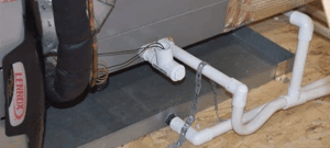 PVC condensate drain piping expertly connected to an HVAC unit on a sturdy platform, with secure trap and vent for safe drainage.