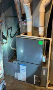 A basement HVAC furnace stands expertly installed with PVC piping and clear labels—reflecting Black Diamond's trusted, 24/7 home service.