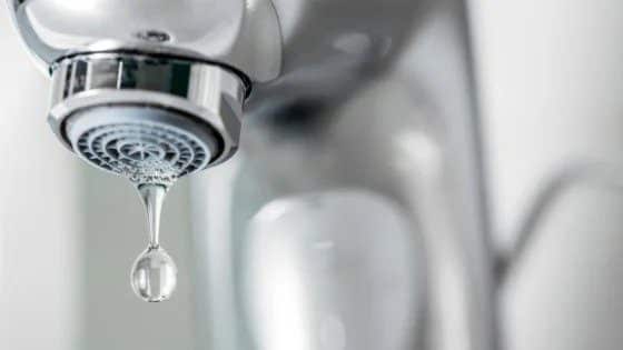 A close-up of a metal faucet with a water droplet, symbolizing Black Diamond Experts’ reliable 24/7 home comfort services in Utah.