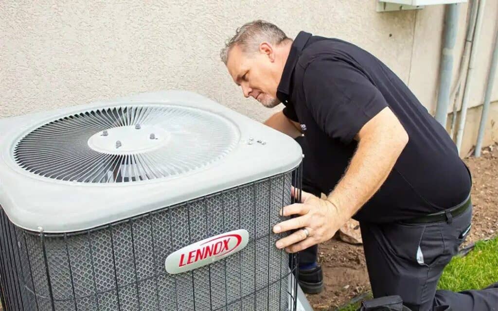A Black Diamond Experts technician expertly checks a Lennox AC unit, ensuring safe, reliable 24/7 comfort for Utah homes.