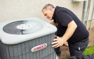 A Black Diamond Experts technician expertly checks a Lennox AC unit, ensuring safe, reliable 24/7 comfort for Utah homes.