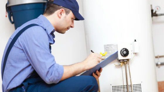 A trusted Black Diamond Experts technician checks a water heater, assuring Utah homes of 24/7 expert plumbing and HVAC care.
