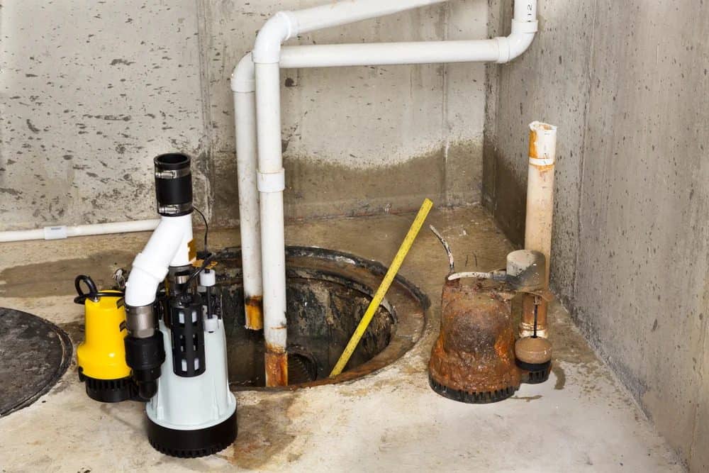 A reliable sump pump system with twin pumps, PVC pipes, and measuring stick in a basement, backed by Utah’s trusted 24/7 experts.